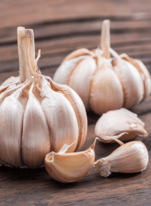 Garlic bulb and garlic cloves on the wooden table