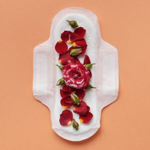 Red roses in period pad signifying bleeding