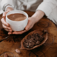 Person Giving Ceremonial Cacao in Cup. Chocolate Drink Top View