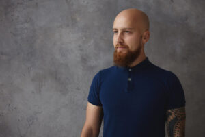 Bald man in navy shirt