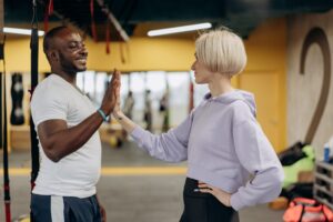 PT high-fiving a client after workout