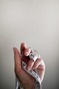 hand holding measuring tape