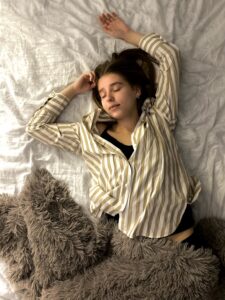 women in striped pyjamas sleeping in bed