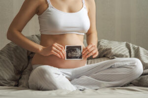 woman holding ultrasound baby photo 