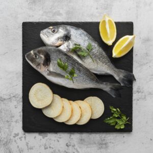 Oily fish with slices of lemon