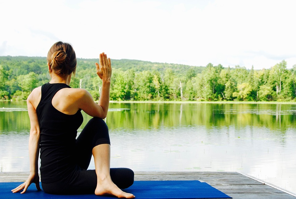 a woman doing a yoga at the river