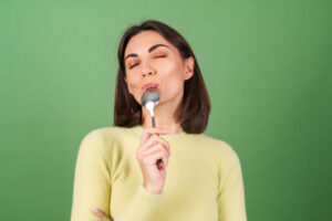 Woman eating from spoon